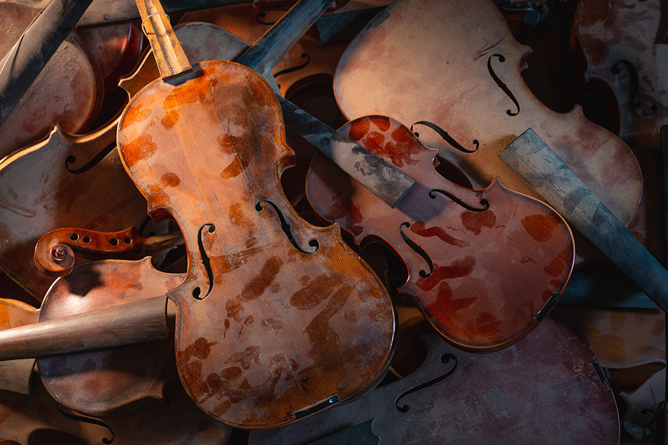 top down view on a pile of old dusty broken Violins and Violas in color